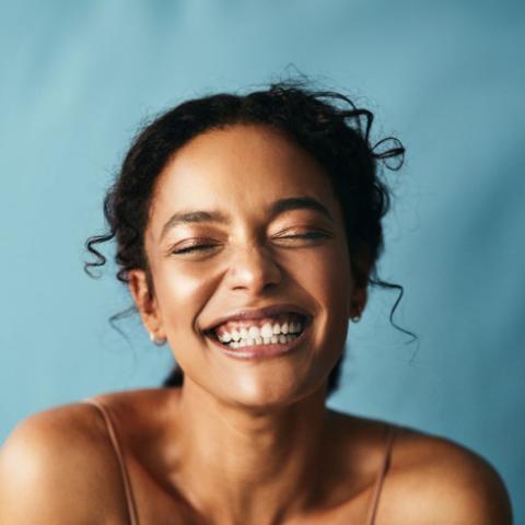 A headshot of a young woman grinning broadly.